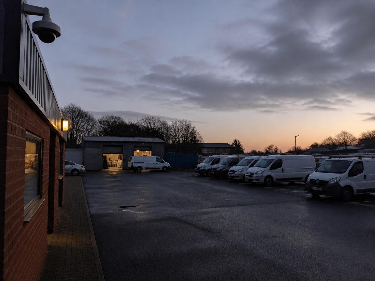 Business premises and vehicle yard covered by a CCTV camera at dusk